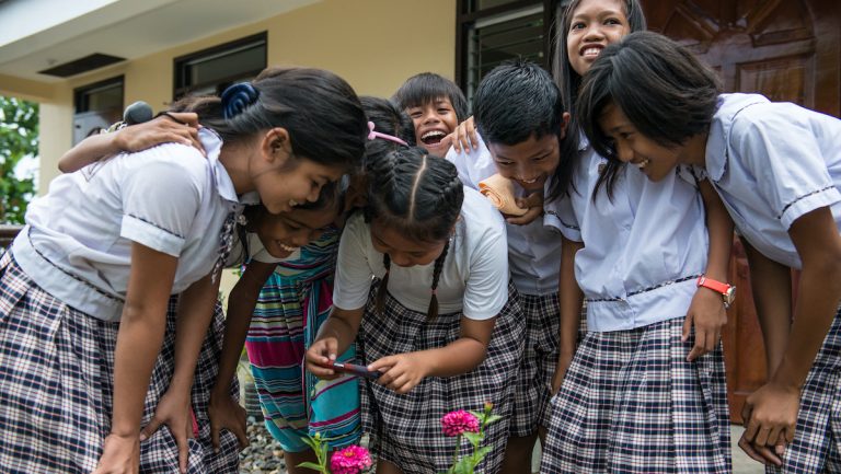 Photo of school children using smartphone