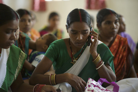 A young woman in India speaks on a mobile phone.
